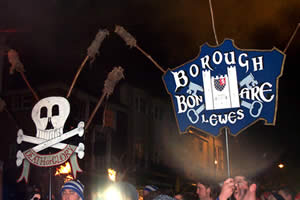  Two of Lewes Borough Bonfire Society's banners being carried in procession, the torches still unlit  